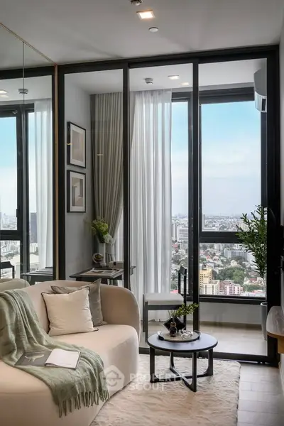 Modern living room with city view, cozy seating, and elegant decor in a high-rise apartment.