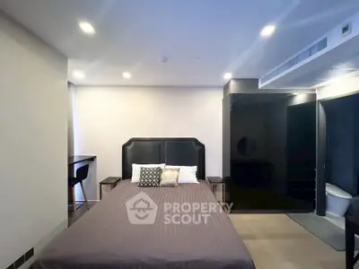 Modern bedroom with stylish decor and ensuite bathroom in luxury apartment