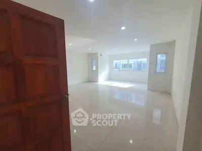 Spacious and bright empty room with large windows and tiled flooring, perfect for customization.