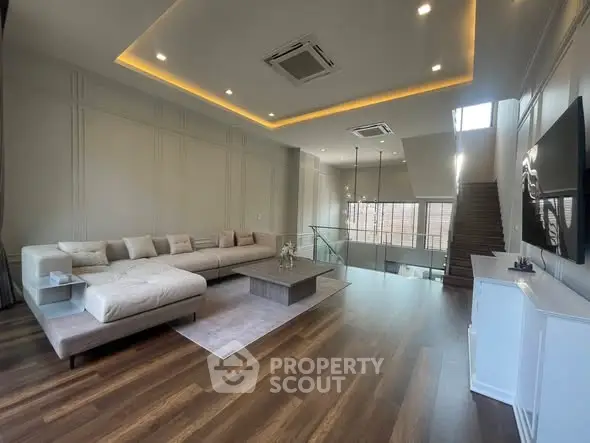 Spacious modern living room with elegant lighting and stylish furniture