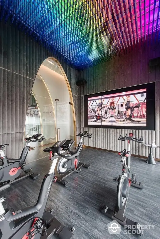 Luxurious gym with modern exercise bikes and vibrant ceiling design