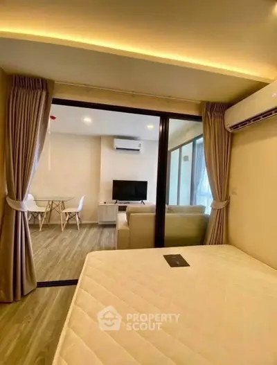 Modern apartment interior with open layout, featuring a cozy living room and dining area, perfect for urban living.