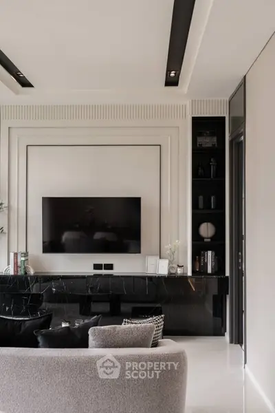 Luxurious modern living room with sleek black marble accents and wall-mounted TV
