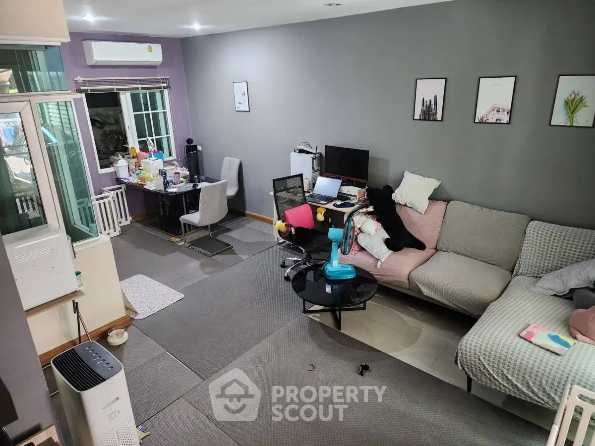Spacious living room with modern decor and home office setup