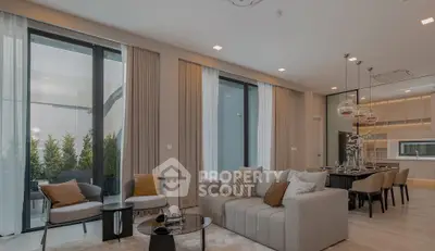 Luxurious modern living room with elegant decor and open kitchen layout, perfect for entertaining.