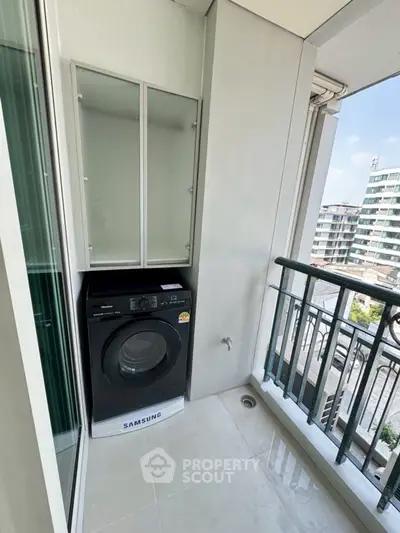 Modern balcony with washing machine and city view, perfect for urban living convenience.