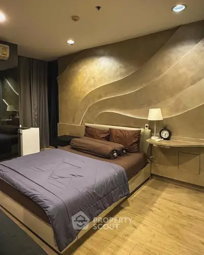 Luxurious bedroom with modern design and ambient lighting, featuring a stylish accent wall and cozy bedding.