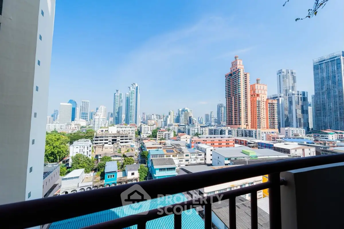 Stunning cityscape view from a high-rise balcony in a vibrant urban area.
