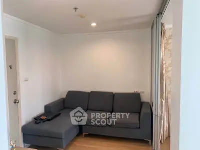 Cozy living room with modern gray sofa and wooden flooring