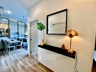 Modern living room with stylish decor and open layout, featuring sleek furniture and warm lighting.