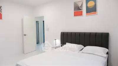 Modern bedroom with stylish decor and comfortable bed in a bright, minimalist setting.