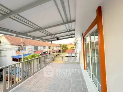 Spacious balcony with tiled flooring and neighborhood view, perfect for relaxation and outdoor activities.