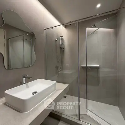 Modern bathroom with sleek glass shower and stylish sink design