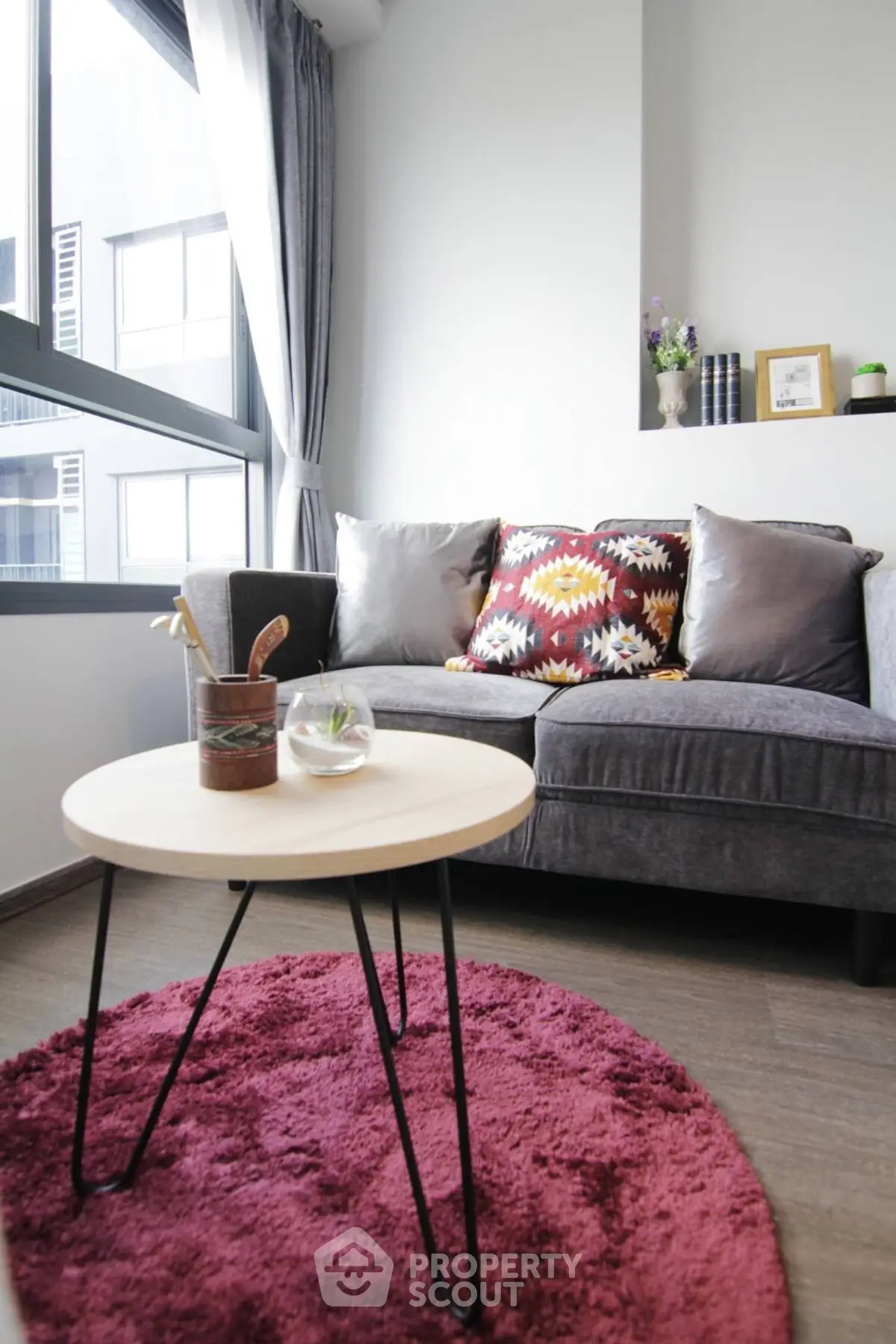 Chic modern living room with stylish sofa and vibrant decor in a bright apartment.