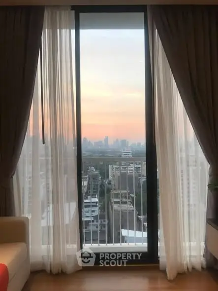 Stunning city view from a modern apartment's large window, perfect for urban living.
