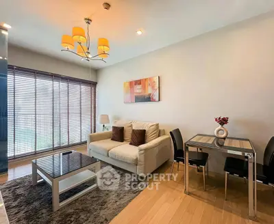 Modern living room with cozy sofa, stylish dining area, and elegant lighting in a bright apartment.