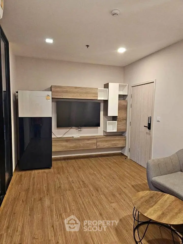 Modern living room with stylish wooden flooring and sleek TV unit