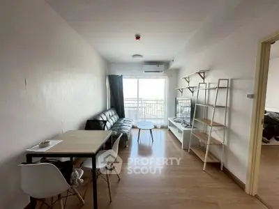 Modern living room with balcony, sleek furniture, and natural light in a stylish apartment.