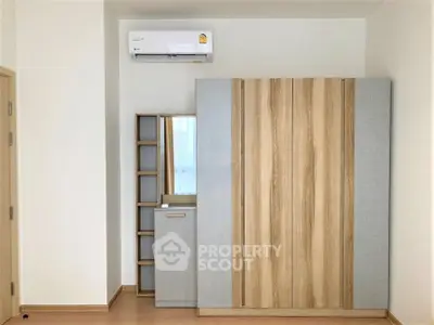 Modern bedroom with sleek wardrobe and air conditioning unit
