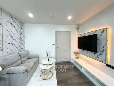 Modern living room with stylish marble accents and sleek TV setup