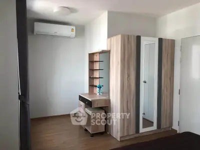 Modern bedroom with wooden furniture and air conditioning in a stylish apartment.