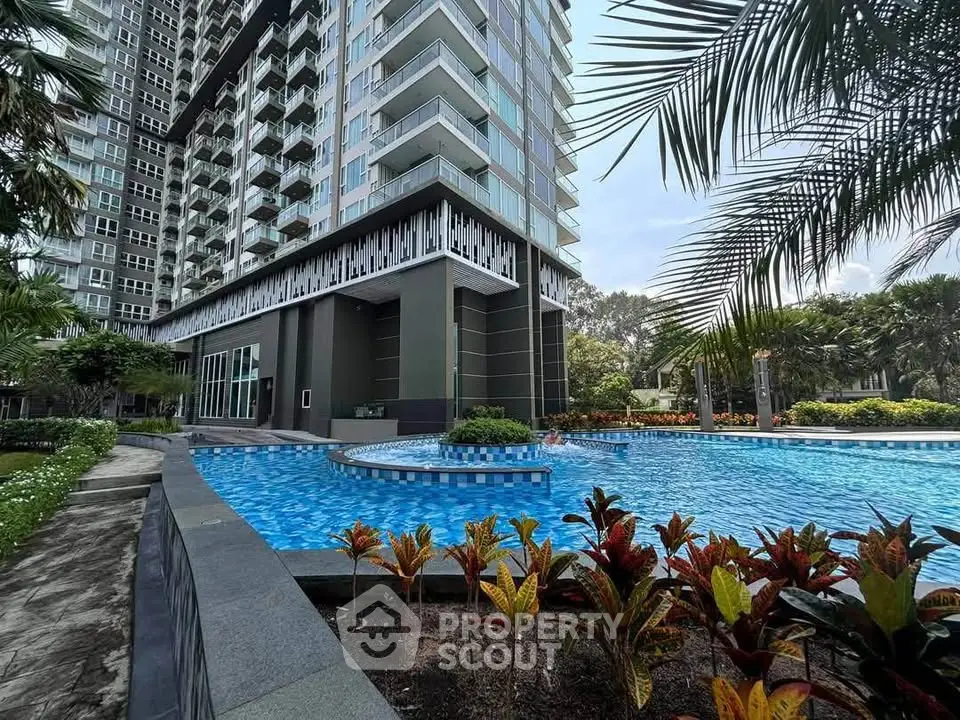 Luxurious apartment building with stunning pool and lush greenery