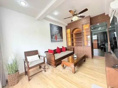 Charming living room with wooden furniture and ceiling fan in cozy apartment