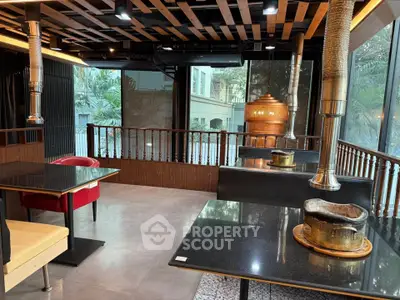 Modern restaurant interior with stylish wooden ceiling and cozy seating, perfect for dining and social gatherings.