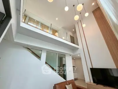 Stunning modern living room with high ceilings and elegant lighting fixtures