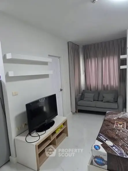 Modern living room with TV and cozy sofa in a compact apartment