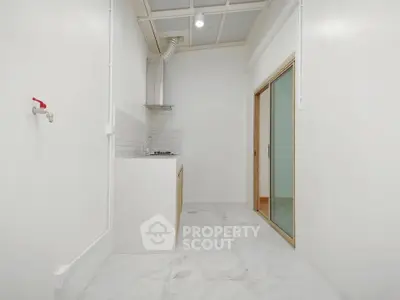 Minimalist kitchen with sleek design and gas stove in compact space