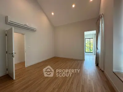 Spacious modern living room with high ceiling and wooden flooring
