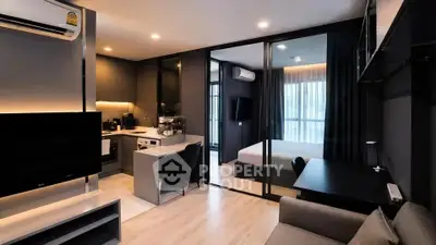 Modern open-plan living room with kitchen and bedroom in sleek apartment