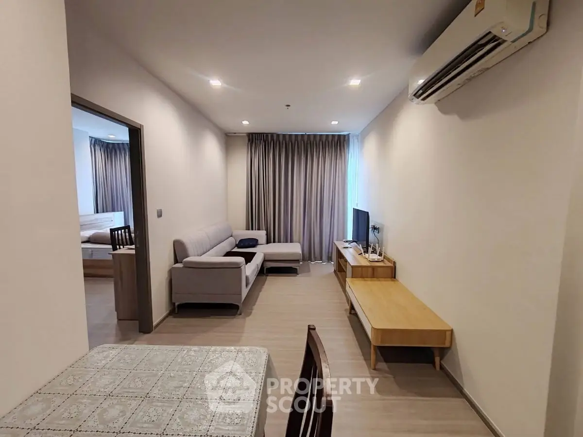 Modern living room with cozy sofa and sleek TV unit in stylish apartment.