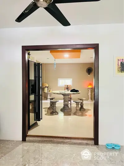 Elegant interior with unique stone table and modern ceiling fan