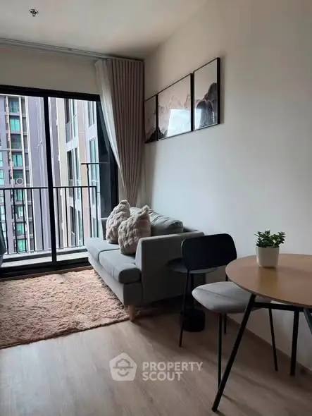 Cozy modern living room with balcony view in urban apartment