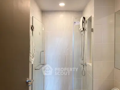 Modern bathroom with glass shower enclosure and sleek tile design