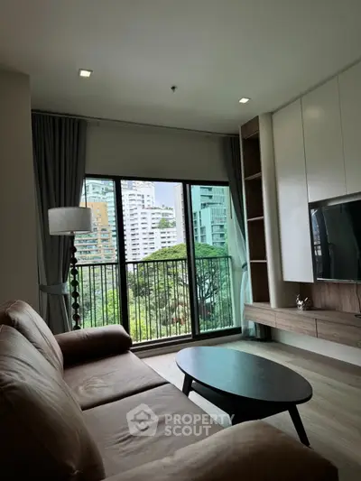 Modern living room with large window and city view, featuring sleek furniture and natural light.
