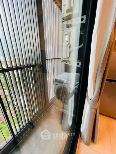 Modern balcony with city view and laundry area in high-rise apartment