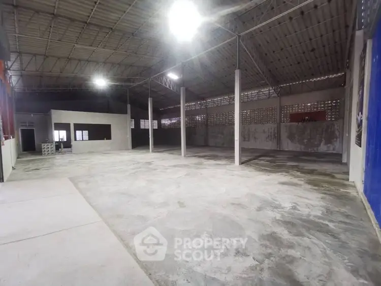 Spacious industrial warehouse with high ceilings and ample open floor space.