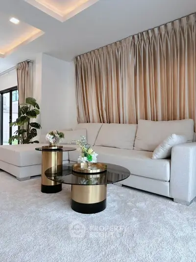Luxurious living room with elegant sofa and stylish coffee tables, perfect for modern living.