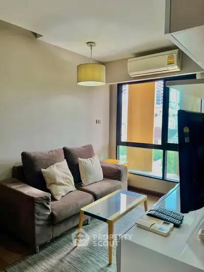 Cozy living room with modern sofa and large window view