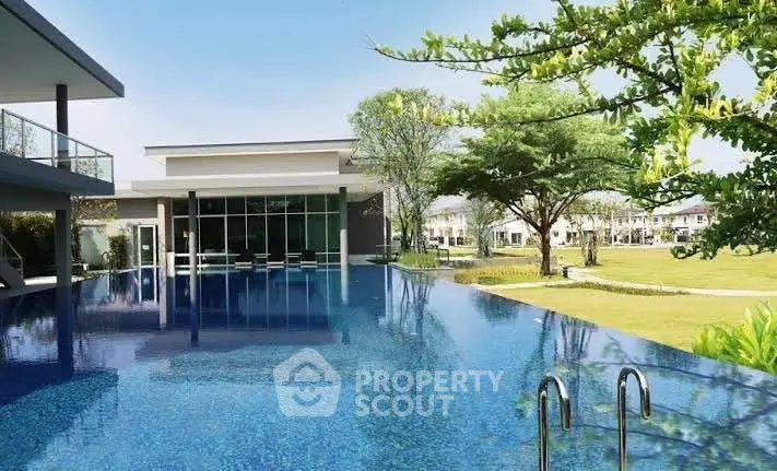 Luxurious modern home with stunning infinity pool and lush garden view.