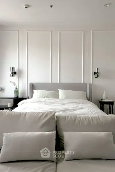 Luxurious bedroom with elegant decor and plush bedding in a modern apartment.