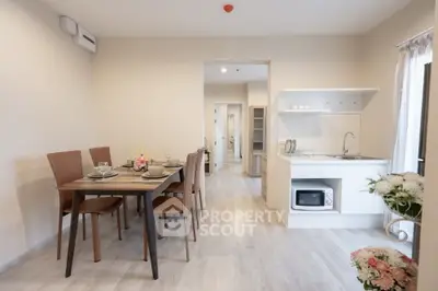 Modern open-plan kitchen and dining area with stylish decor and natural light.