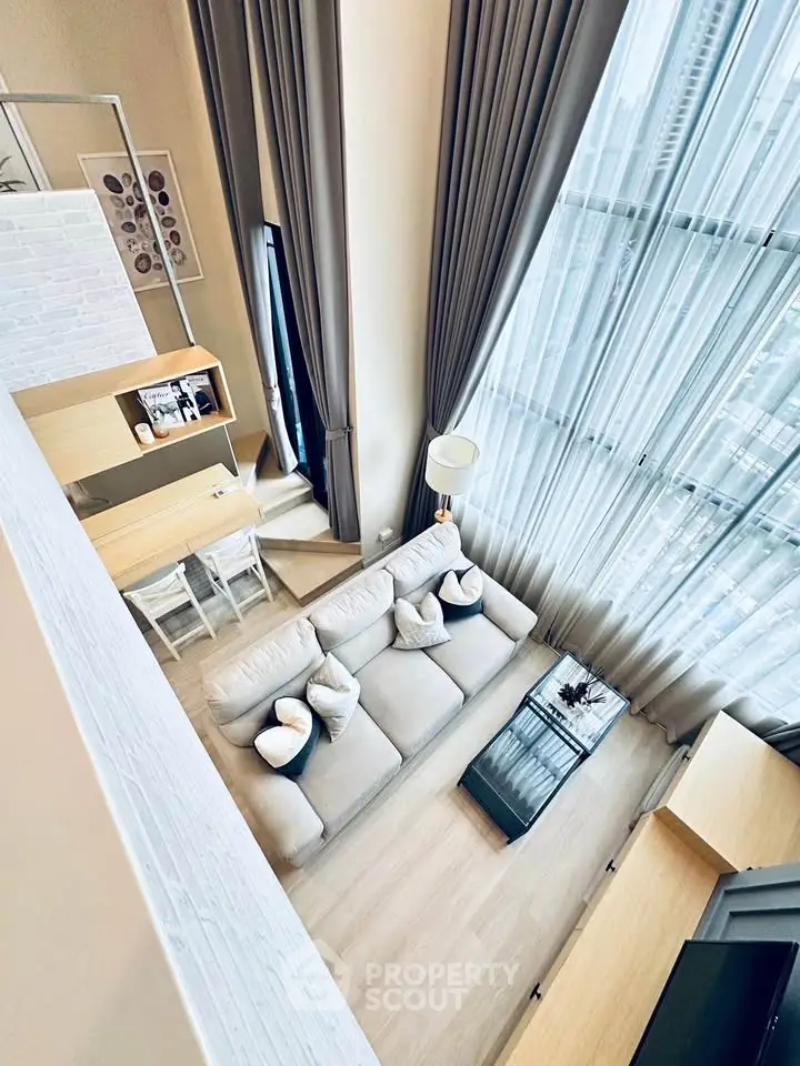 Stunning high-ceiling living room with floor-to-ceiling windows and modern decor in a luxury apartment.