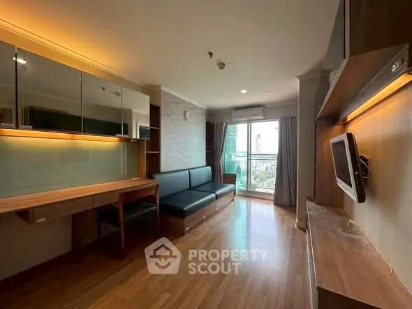 Modern living room with wooden floors, sleek furniture, and balcony view.