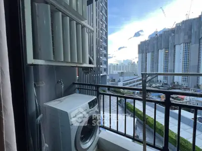 Urban balcony with washing machine and city view, perfect for modern living.