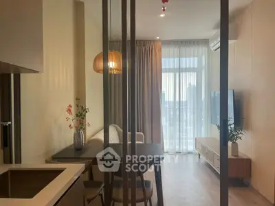 Modern living room with open layout and stylish decor, featuring a dining area and large window view.