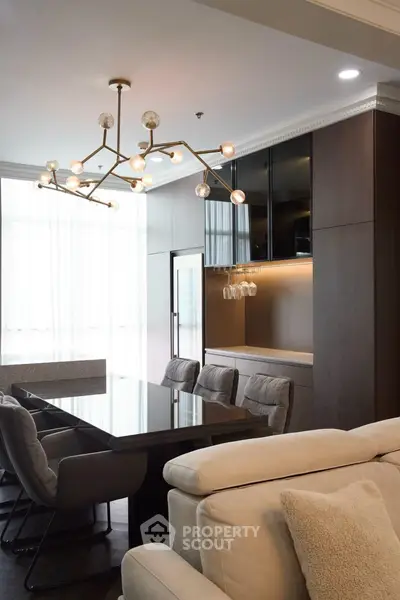 Luxurious modern living room with elegant chandelier and plush seating